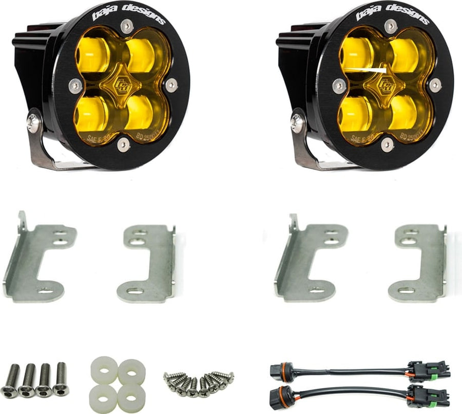 Fog Light Kits by Baja Designs: Pair of round Squadron-R pods with amber lenses, steel brackets, screws, washers and two pigtail harnesses laid out on a white background.