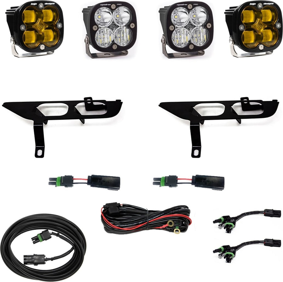 Fog Light Kits by Baja Designs: Four square Squadron pods, two black fog pocket brackets, pigtail adapters and harness, two amber and two clear lenses laid out on a white background.