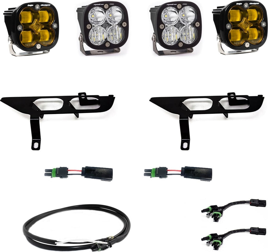 Fog Light Kits by Baja Designs: Four square Squadron pods, two black fog pocket brackets, pigtail adapters and harness, two amber and two clear lenses laid out on a white background.