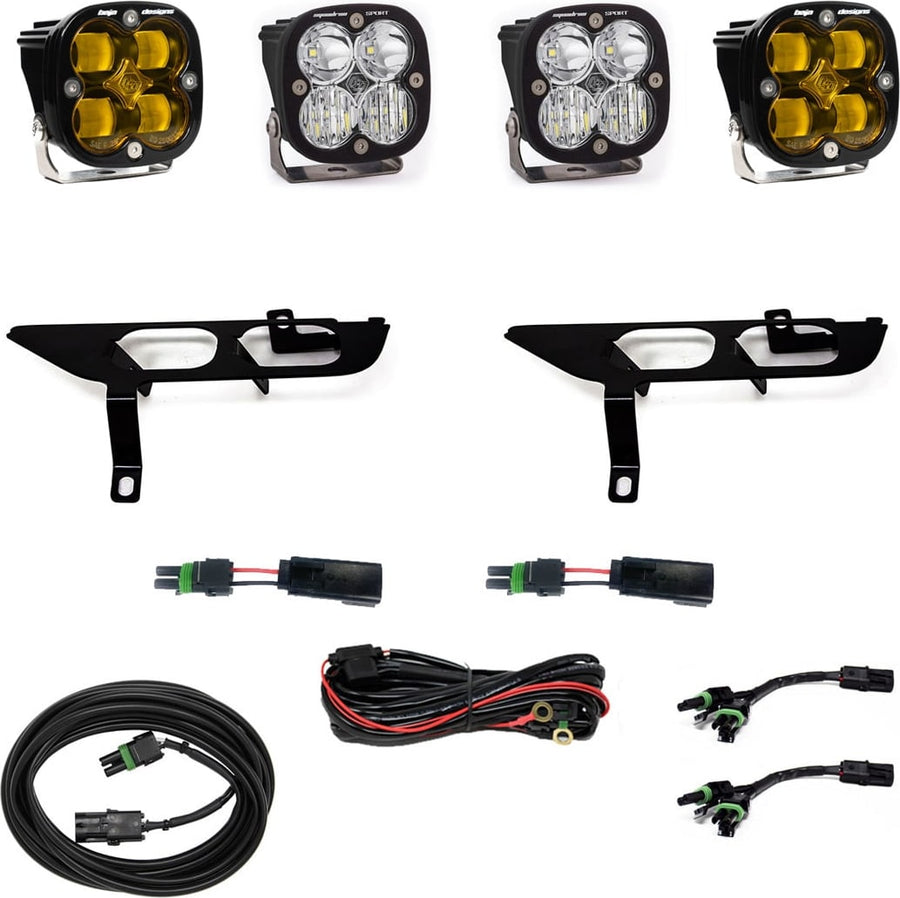 Fog Light Kits by Baja Designs: Four square Squadron pods, two black fog pocket brackets, pigtail adapters and harness, two amber and two clear lenses laid out on a white background.