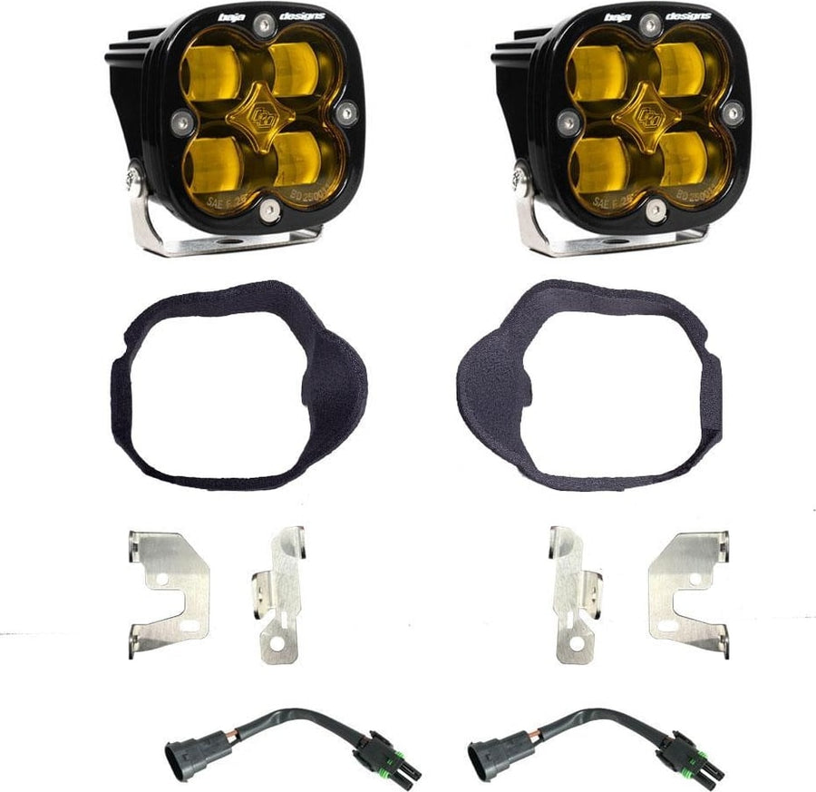 Fog Light Kits by Baja Designs: Pair of square Squadron pods with fabric-wrapped fog bezel rings, steel brackets and two pigtail harnesses, amber lenses laid out on a white background.