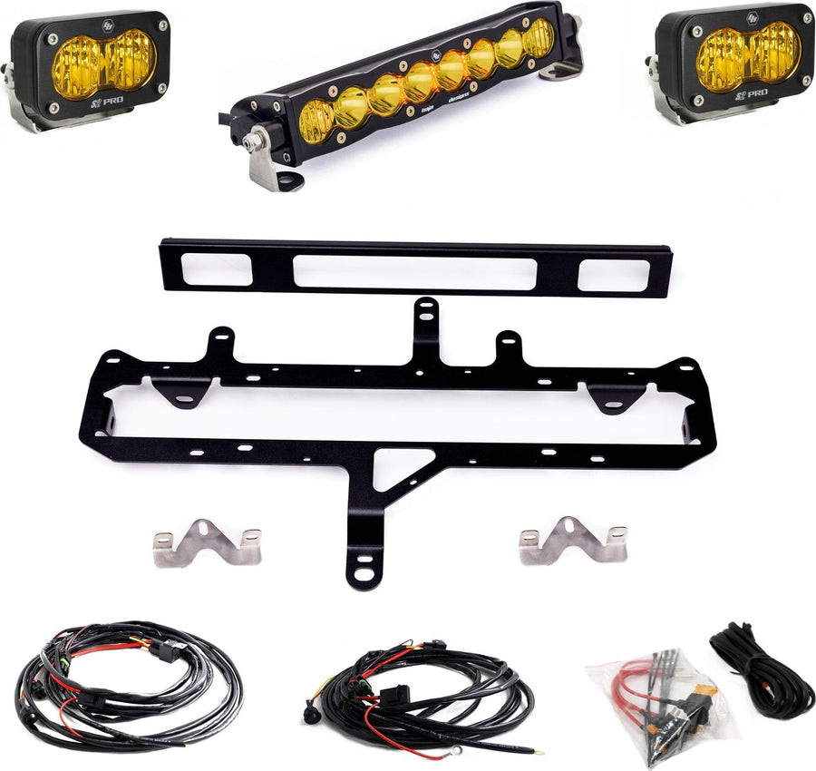 Grille Light Kits by Baja Designs: An amber S8 10-inch light bar, two amber S2 Pro pods, a black grille mounting frame, wiring harnesses and hardware laid out on white.