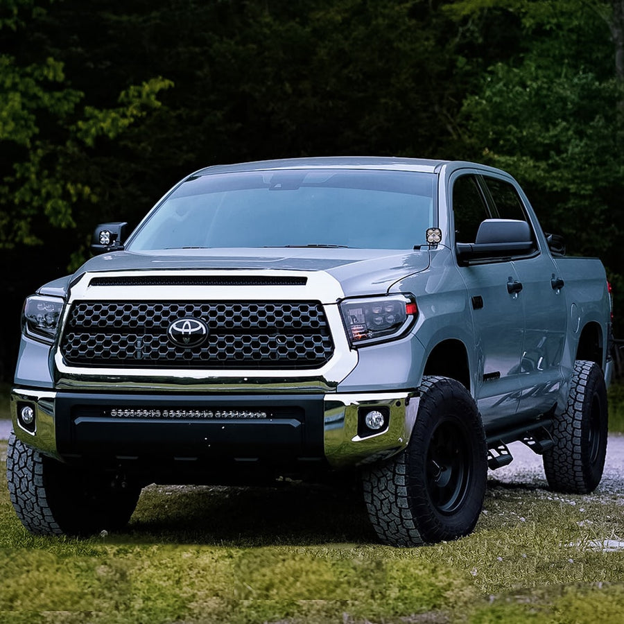 Grille Light Kits by Baja Designs: A silver Toyota Tundra parked on grass with an S8 light bar mounted in the lower grille opening.