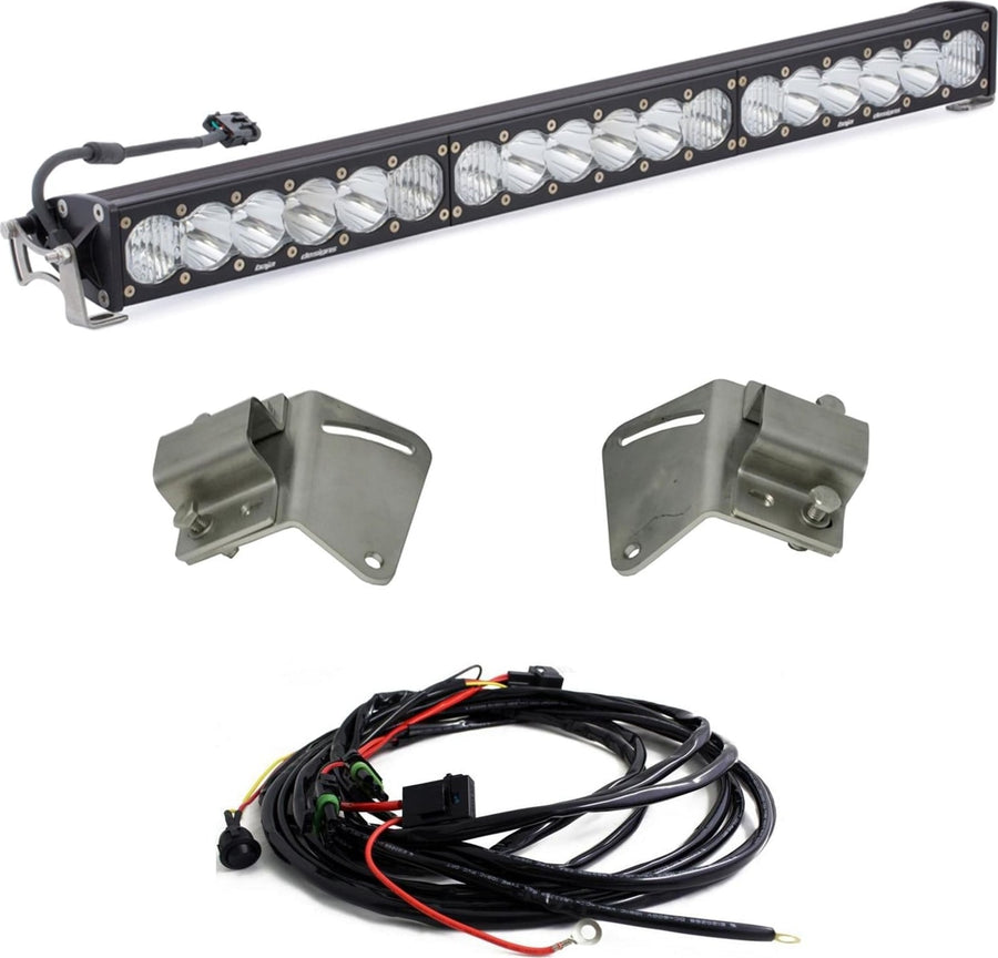 Grille Light Kits by Baja Designs: A 30-inch OnX6+ LED light bar with clear lenses, two gray steel mounting brackets and a wiring harness on white.