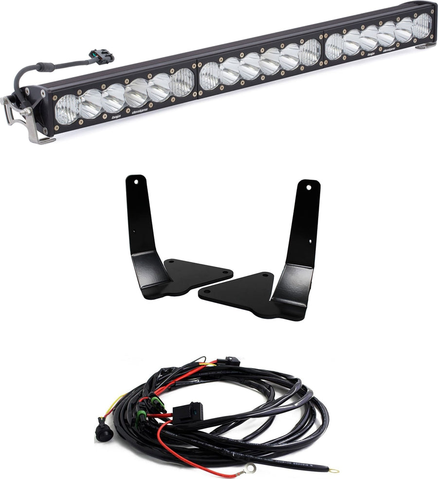 Grille Light Kits by Baja Designs: A 30-inch OnX6+ LED light bar with clear lenses, two black mounting brackets and a wiring harness on white.