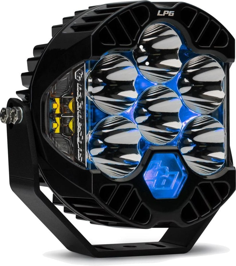LP Light Pods by Baja Designs: Front three-quarter view of a single black LP6 Pro LED light pod clear lens, spot optics, blue backlight glowing on its mounting bracket against a white background.