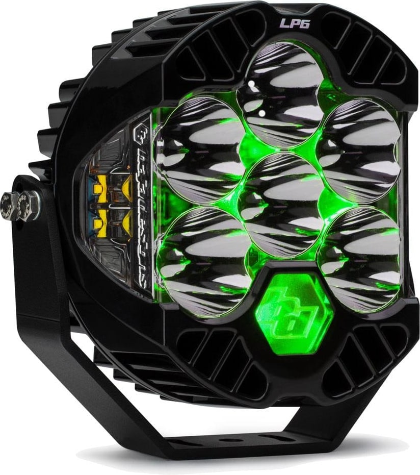 LP Light Pods by Baja Designs: Front three-quarter view of a single black LP6 Pro LED light pod clear lens, spot optics, green backlight glowing on its mounting bracket against a white background.