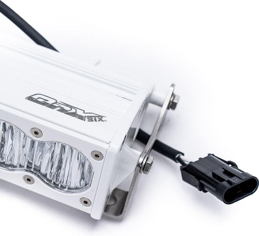 LED Light Bars by Baja Designs: Close view of the end of a white LED light bar with its bracket, OnX6 logo and wiring connector.