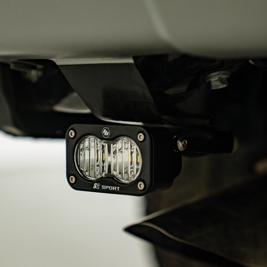 Reverse Light Kits by Baja Designs: S2 Sport LED pod mounted on a bracket beneath a vehicle rear bumper.