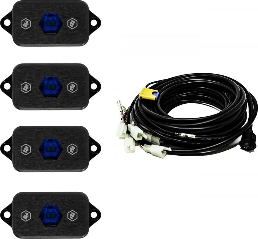 Rear & Utility Lights by Baja Designs: Four black LED rock light pods with blue centers shown with a coiled multi-lead wiring harness on white.