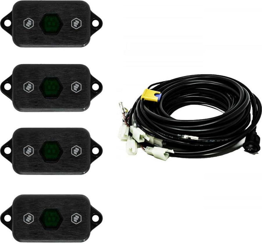 Rear & Utility Lights by Baja Designs: Four black LED rock light pods with green centers shown with a coiled multi-lead wiring harness on white.