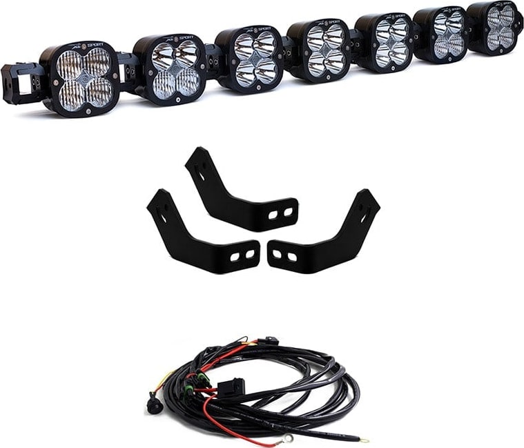 Roof Light Kits by Baja Designs: A seven-pod linkable LED roof bar with black rack brackets and a coiled wiring harness on white.
