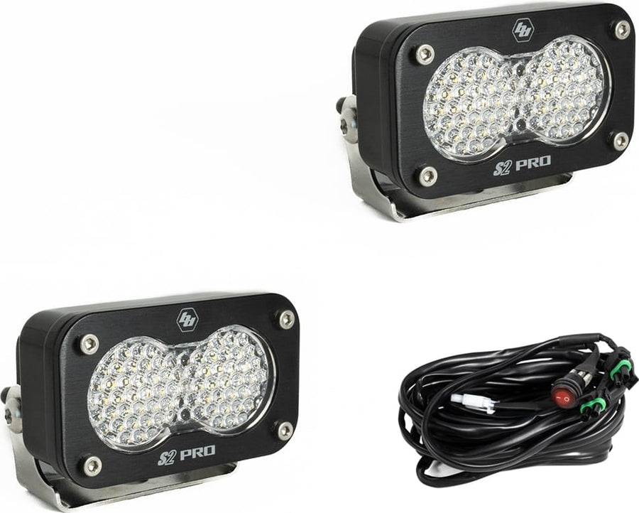 S2 Light Pods by Baja Designs: Two black S2 Pro LED pods with clear dimpled work scene style lenses and a wiring harness with switch on a white background.