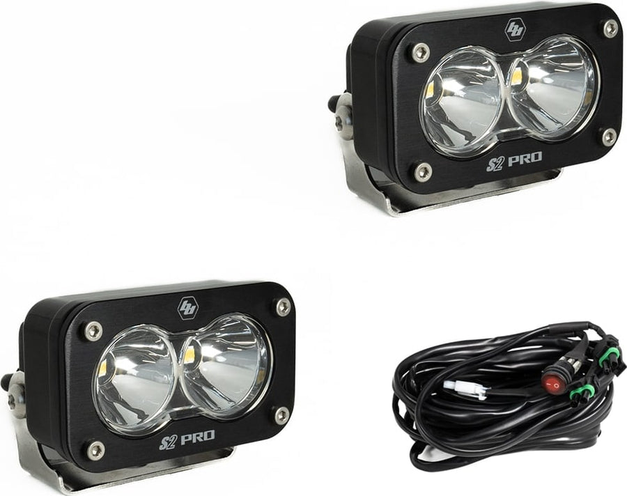 S2 Light Pods by Baja Designs: Two black S2 Pro LED pods with clear smooth spot reflector lenses and a wiring harness with switch on a white background.