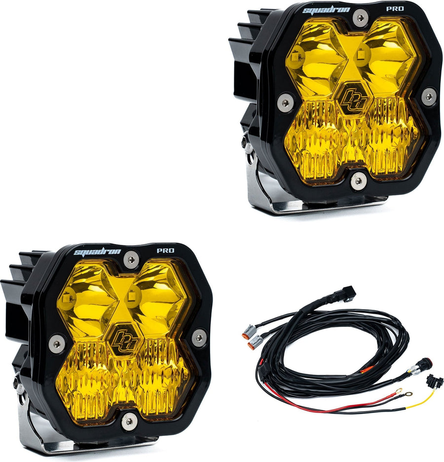 Squadron Light Pods by Baja Designs: Pair of black Squadron Pro pods with amber driving combo lenses, with wiring harness, on white.