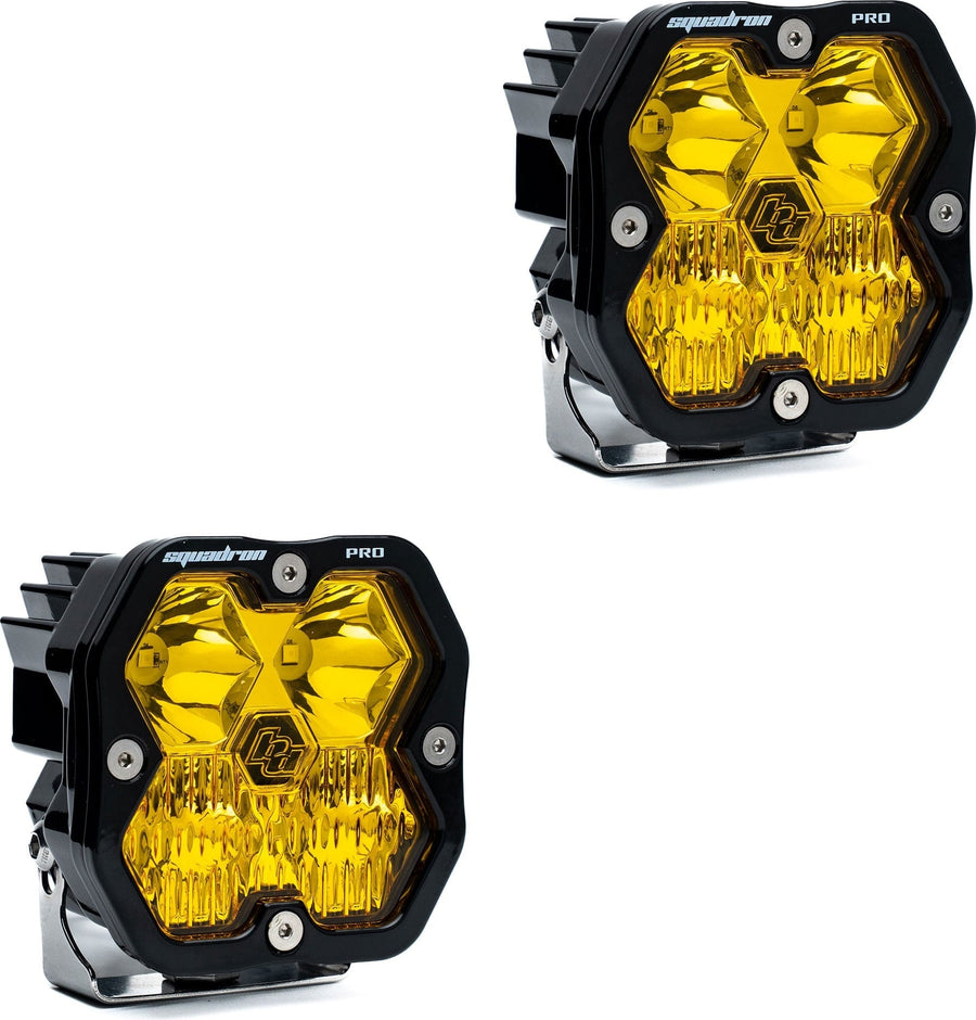 Squadron Light Pods by Baja Designs: Pair of black Squadron Pro pods with amber driving combo lenses, no harness, on white.
