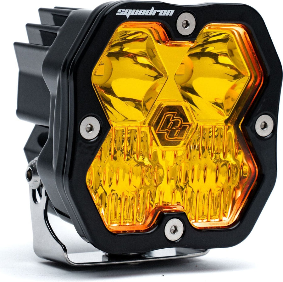 Squadron Light Pods by Baja Designs: Single black Squadron Sport pod with amber driving combo lens and amber glow, on its bracket, on white.