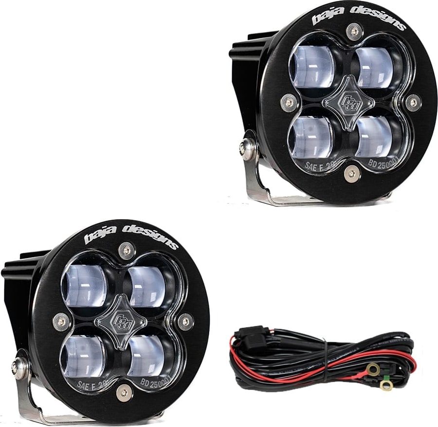 Squadron Light Pods by Baja Designs: Two round black Squadron-R SAE pods with clear lenses and a wiring harness on a white background.
