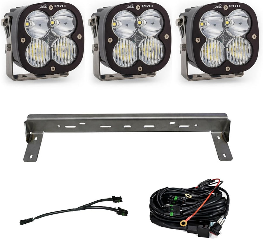 Bumper Light Kits by Baja Designs: Three XL Pro LED pods with clear lenses, a steel bumper mounting bar and wiring harnesses on a white background.
