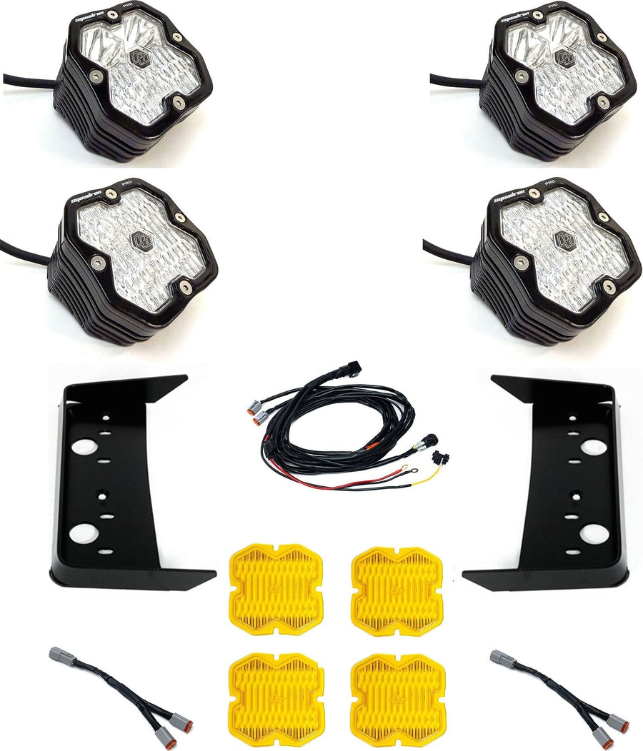 Grille Light Kits by Baja Designs: Four black Squadron Pro pods with clear lenses laid out with two black vent brackets, a harness, two splitters and four amber covers on white.