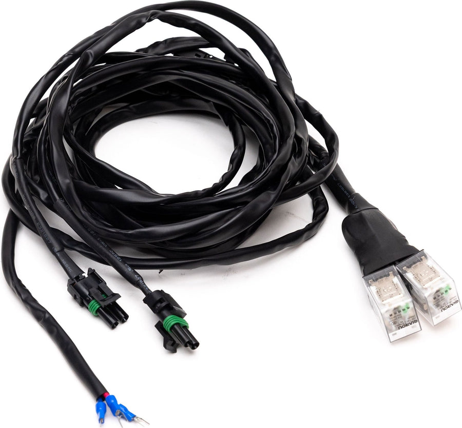 Wiring Harnesses by Baja Designs: A black actuator adaptor harness with clear motor plugs, weatherpack connectors and blue spade leads on white.