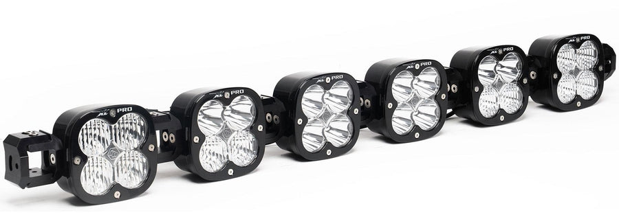 LED Light Bars by Baja Designs: A 6-light black XL Pro Linkable LED light bar with clear lenses and end mounting blocks, shown at a front three-quarter angle on a white background.
