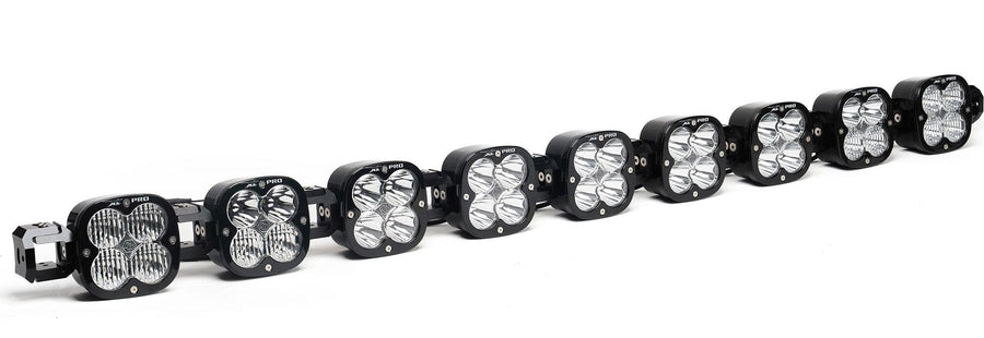 LED Light Bars by Baja Designs: A 9-light black XL Pro Linkable LED light bar with clear lenses and end mounting blocks, shown at a front three-quarter angle on a white background.