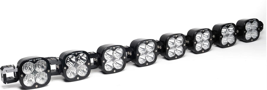 LED Light Bars by Baja Designs: A 8-light black XL Pro Linkable LED light bar with clear lenses and end mounting blocks, shown at a front three-quarter angle on a white background.
