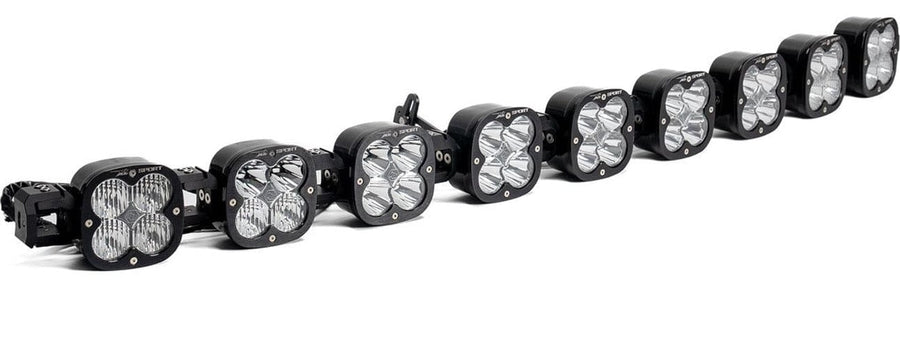 LED Light Bars by Baja Designs: A 9-light black XL Sport Linkable LED light bar with clear lenses and end mounting blocks, shown at a angled side angle on a white background.