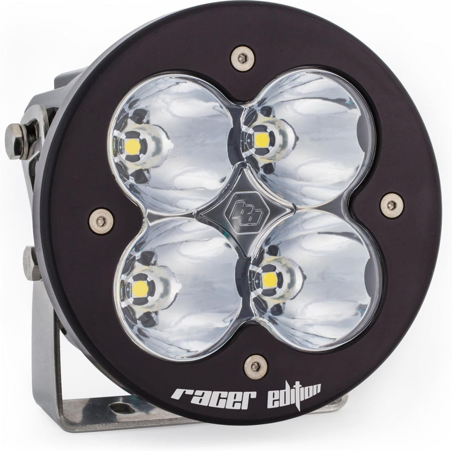 XL Light Pods by Baja Designs: A single black XL-R Racer Edition LED light pod with a clear spot lens on a stainless mounting bracket, on a white background.