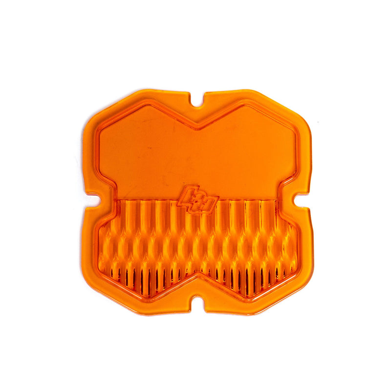 Baja Designs Squadron 2.0 Light Pod 90° Lens Kit, complete kit on a studio background: A orange factory amber Squadron pod lens with a combo optic pattern and a molded Baja Designs logo, shown flat on a white background