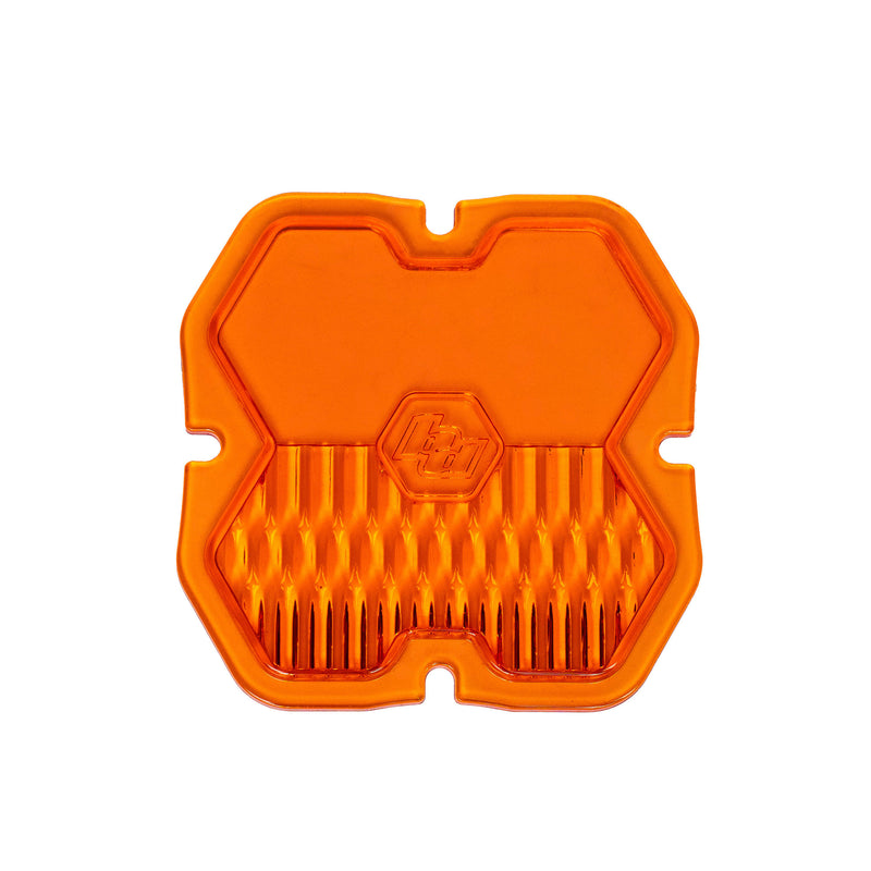 Baja Designs Squadron 2.0 Light Pod Lens Kit, complete kit on a studio background: A orange factory amber Squadron pod lens with a combo optic pattern and a molded Baja Designs logo, shown flat on a white background