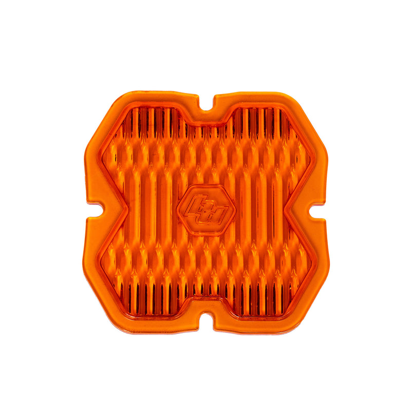 Baja Designs Squadron 2.0 Light Pod Lens Kit, complete kit on a studio background: A orange factory amber Squadron pod lens with a wide cornering optic pattern and a molded Baja Designs logo, shown flat on a white background