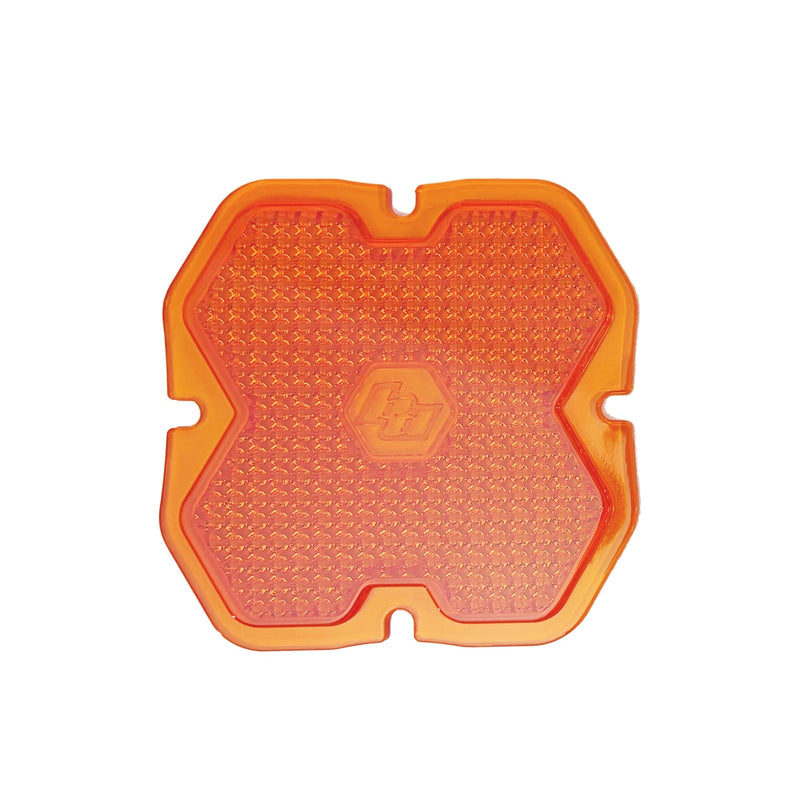 Baja Designs Squadron 2.0 Light Pod Lens Kit, complete kit on a studio background: A orange factory amber Squadron pod lens with a work/scene optic pattern and a molded Baja Designs logo, shown flat on a white background