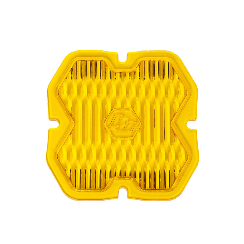 Baja Designs Squadron 2.0 Light Pod Lens Kit, complete kit on a studio background: single yellow Squadron snap-on replacement lens with a wide cornering fluted optic pattern on a white background