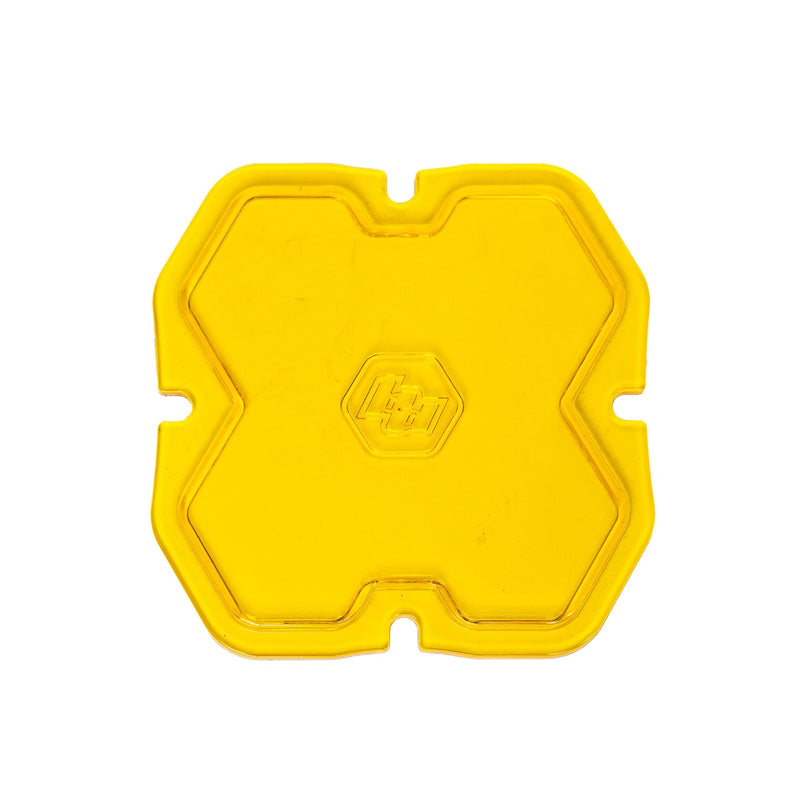 Baja Designs Squadron 2.0 Light Pod Lens Kit, complete kit on a studio background: single yellow Squadron snap-on replacement lens with a smooth spot optic pattern on a white background