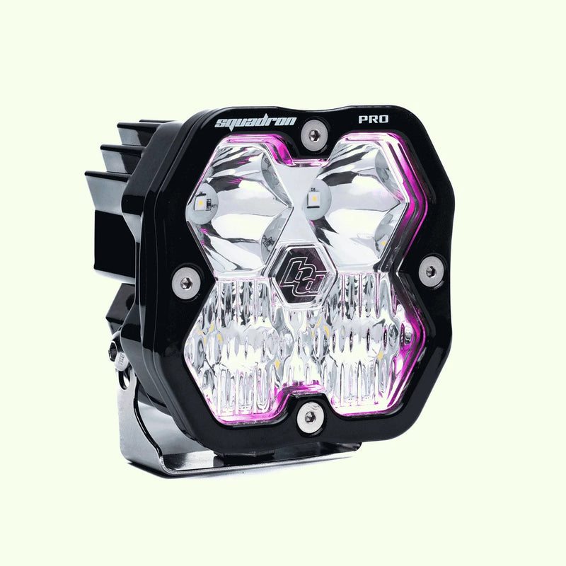 Close-up of the Baja Designs Squadron 2.0 Pro A-Pillar Light Kit: A single Squadron Pro pod with a magenta backlight glowing around a clear lens