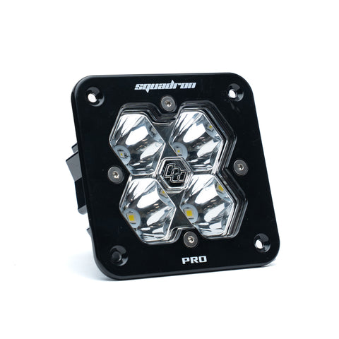 Baja Designs Squadron 2.0 Pro Black Flush Mount LED Auxiliary Light Pod, whole product on a studio background: A black Baja Designs Squadron Pro flush mount LED pod with a clear spot lens on a white background