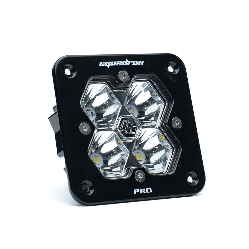 Baja Designs Squadron 2.0 Pro Black Flush Mount LED Auxiliary Light Pod, whole product on a studio background: A black Baja Designs Squadron Pro flush mount LED pod with a clear spot lens on a white background