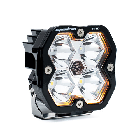 Baja Designs Squadron 2.0 Pro Black LED Auxiliary Light Pod, whole product on a studio background: A black Baja Designs Squadron Pro LED pod with a clear spot lens on a white background