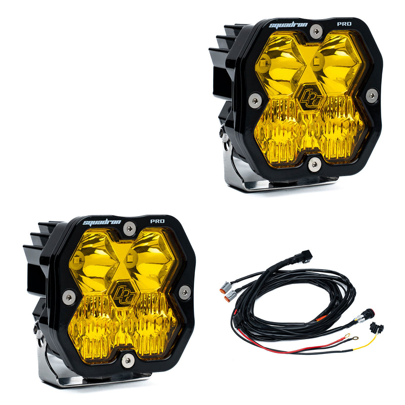 Baja Designs Squadron 2.0 Pro Black LED Auxiliary Light Pod Pair, whole product on a studio background: pair of black Squadron Pro pods with amber driving combo lenses, with wiring harness, on white
