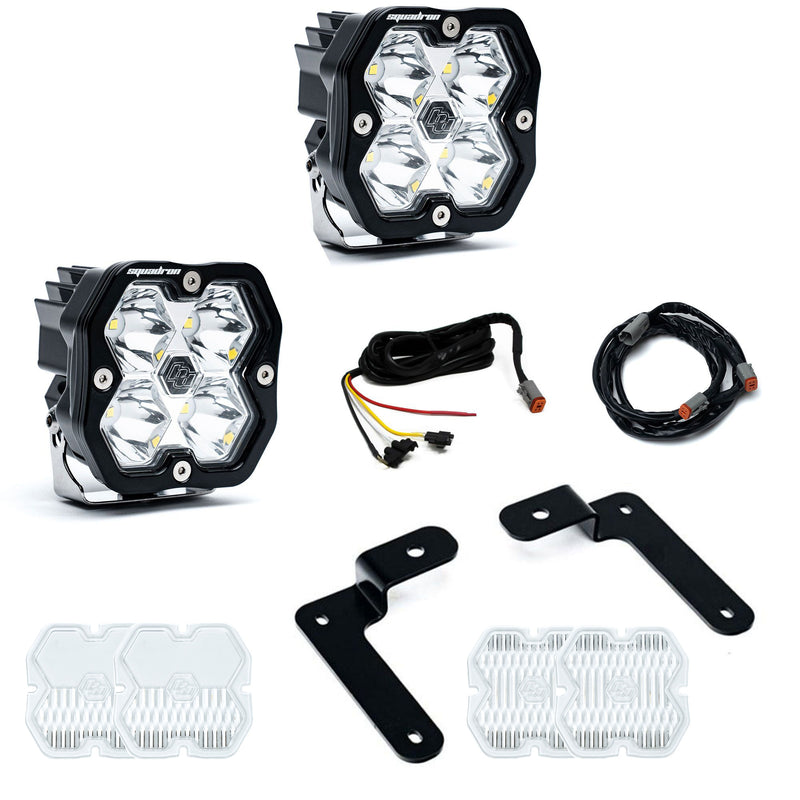 Baja Designs Squadron 2.0 Sport A-Pillar Light Kit, complete kit on a studio background: two Squadron Sport pods, black angled brackets, two harness sections and spare clear lens covers on white