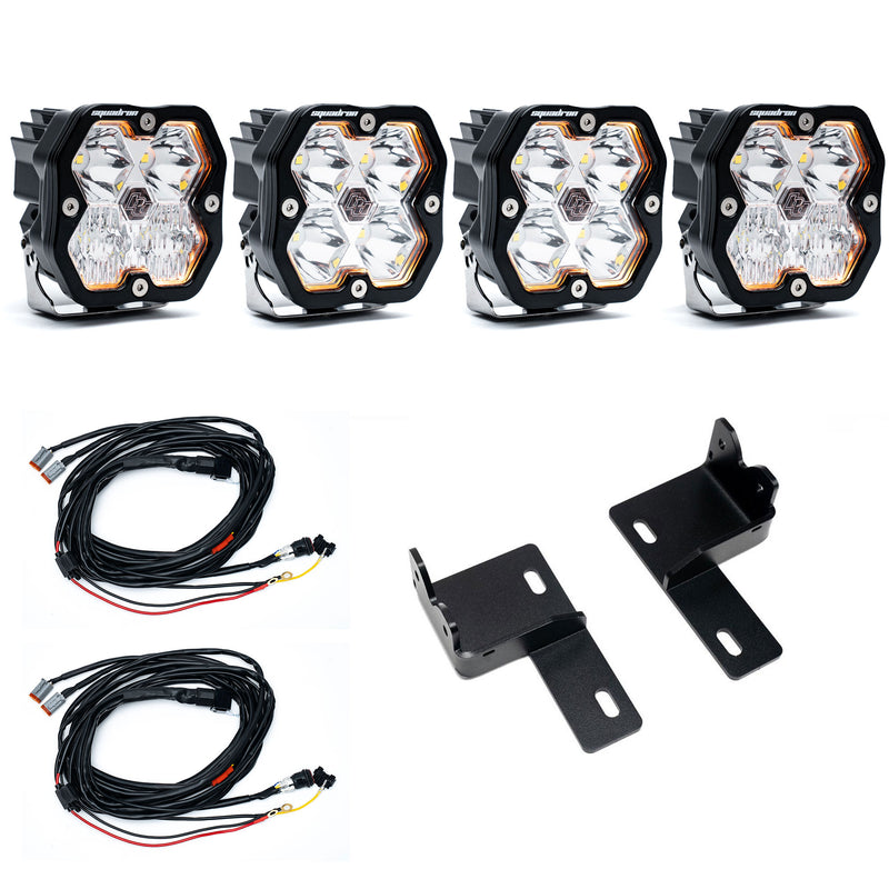 Baja Designs Squadron 2.0 Sport Behind-the-Grille Light Kit, complete kit on a studio background: four clear Squadron 2.0 pods with two wiring harnesses and two black steel brackets on white