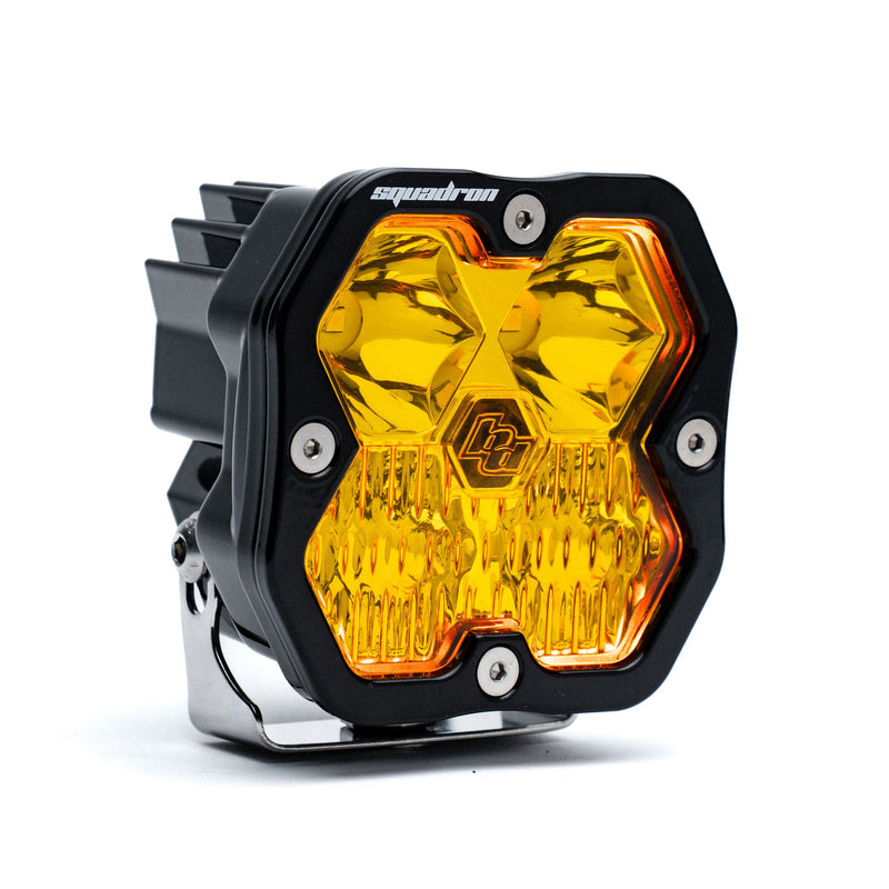 Baja Designs Squadron 2.0 Sport Black LED Auxiliary Light Pod, whole product on a studio background: single black Squadron Sport pod with amber driving combo lens and amber glow, on its bracket, on white