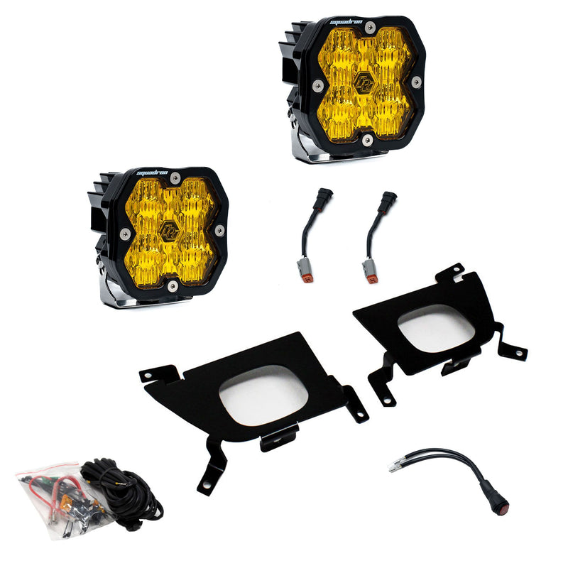 Baja Designs Squadron 2.0 Sport Fog Pocket Light Kit, complete kit on a studio background: pair of square Squadron pods with amber lenses, two black fog pocket brackets, wiring harness and adapters on white