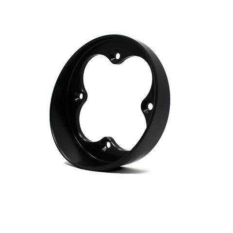 Baja Designs Squadron Angled Bezel, whole product on a studio background: A black round angled bezel with a four-lobe Squadron opening shown from a lower angle on a white background