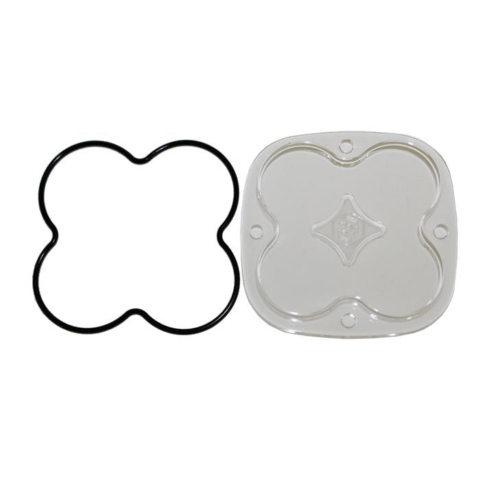 Baja Designs Squadron Light Pod Lens Kit, complete kit on a studio background: A clear rounded-square Squadron replacement lens with a smooth spot optic lies beside its black O-ring gasket on a white background