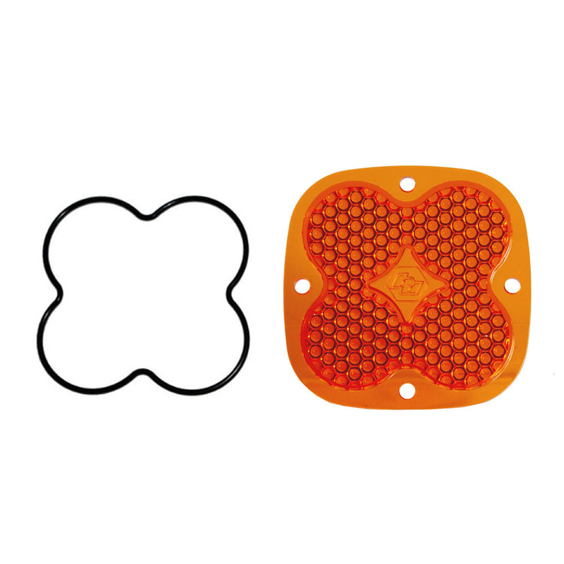 Baja Designs Squadron Light Pod Lens Kit, complete kit on a studio background: A orange-amber rounded-square Squadron replacement lens with a dimpled work/scene optic lies beside its black O-ring gasket on a white background