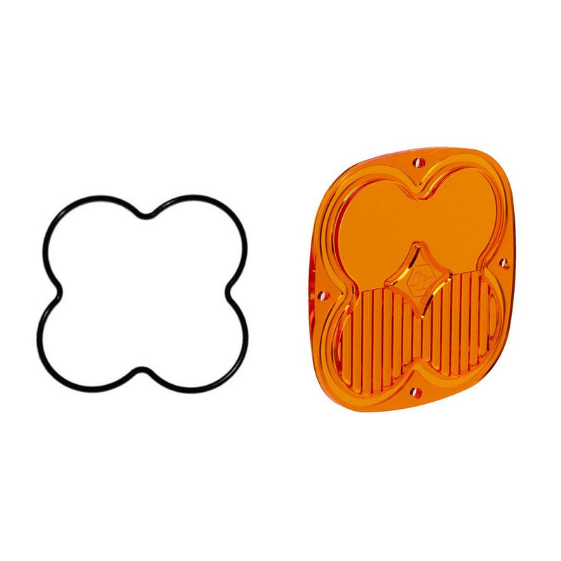Baja Designs Squadron Light Pod Lens Kit, complete kit on a studio background: A orange-amber rounded-square Squadron replacement lens with a half-fluted driving/combo optic lies beside its black O-ring gasket on a white background