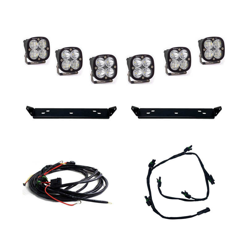 Baja Designs Squadron Pro Behind Grille Light Kit, complete kit on a studio background: six square Squadron LED pods with clear lenses, two black mounting plates and two wiring harnesses on white